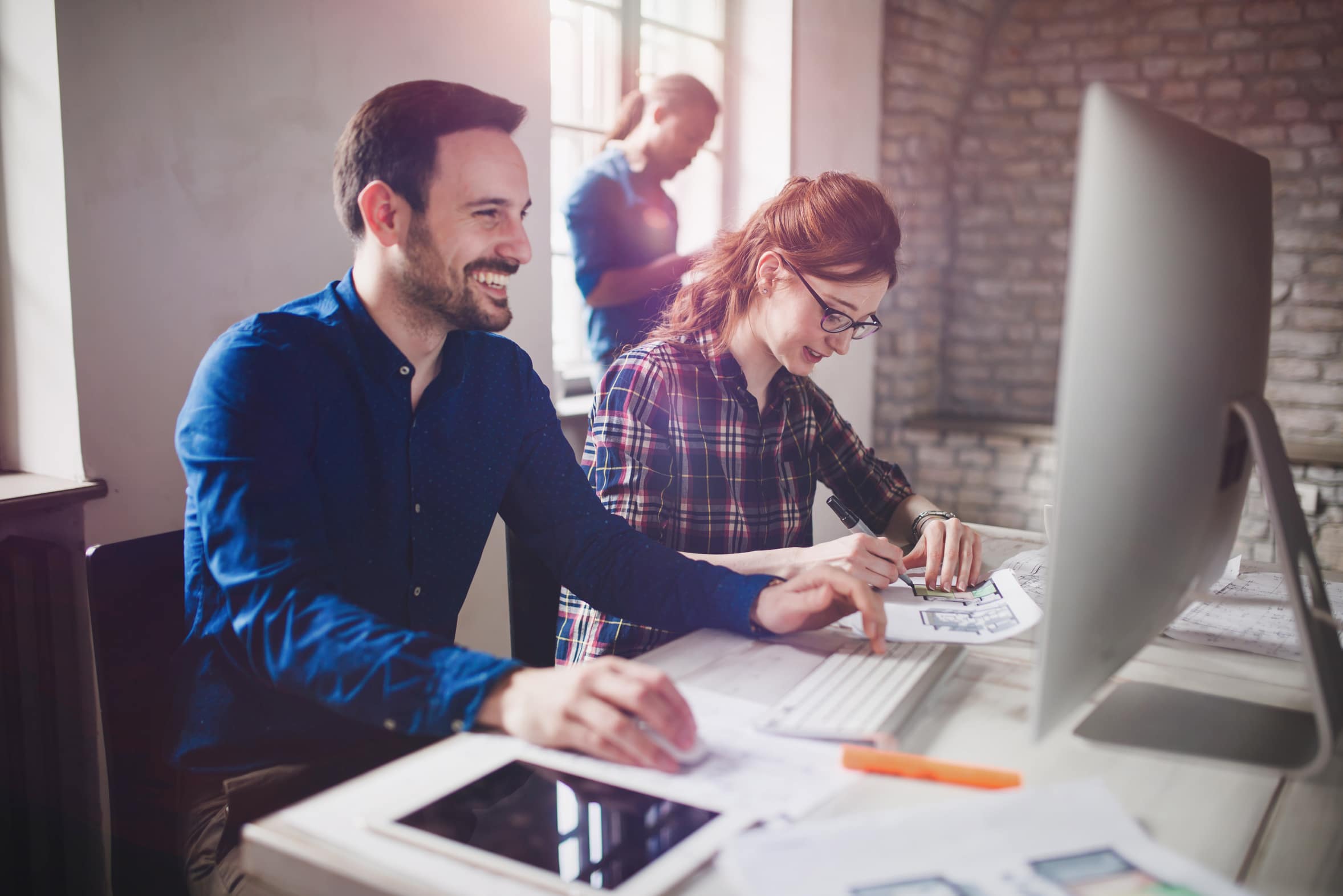 Coworking and corporate colleagues working in designer architect office
